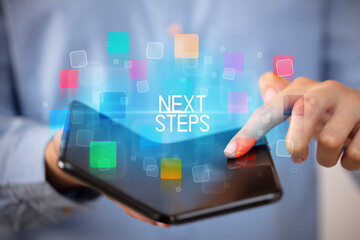 Young man holding a foldable smartphone