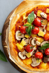 Vegan pizza with tomatoes and mushrooms