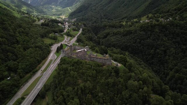 Medieval castle ruins on a hill in Mesocco in a big mountain valley, Switzerland