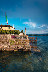 Fototapeta na wymiar Orta San Giulio / Italy - June 2021: View of a building on Lake Orta with the Island of San Giulio in the background