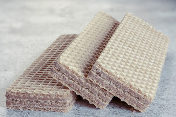 Delicious wafer sticks with chocolate on background. Selective focus.