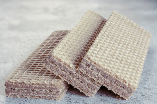 Delicious wafer sticks with chocolate on background. Selective focus.