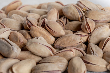 Heap of tasty pistachio with shell background. Pistachio nuts texture, banner for web. Selective focus. Close up.
