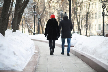Young couple walking through the winter