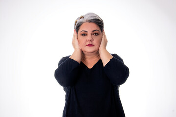 people diversity young lady with white hair covering her ears with hands wearing black on white background