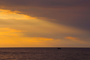 Beautiful summer sunset over the baltic sea. The sun rays pass through the clouds