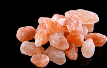Pink Himalayan salt on a black background.