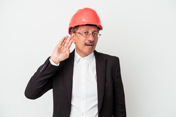 Middle aged indian architect man isolated on white background trying to listening a gossip.