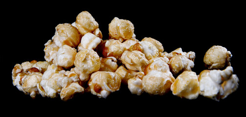 A bunch of popcorn in caramel on a black background