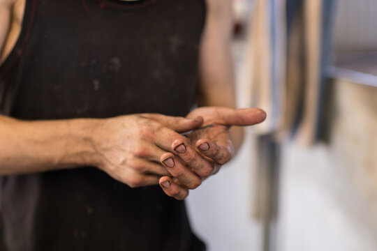 dirty shearers hands holding shearing comb