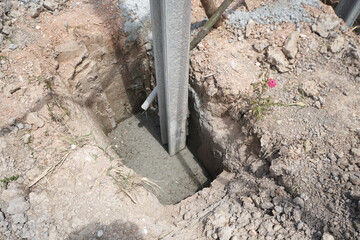 Concrete footings and i beam concrete pile for fences that are installed non-standard. The pole is...