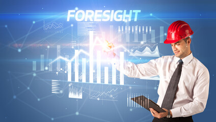 Young businessman with helmet drawing on virutal screen