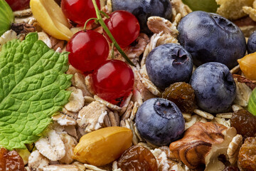 background of mint, nuts, berries, oatmeal and raisins