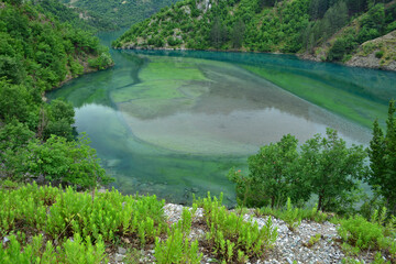 Koman Lake with colorful green and turquoise water