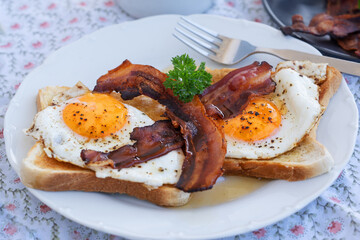 Toast mit Spiegelei und gebratenem Speck