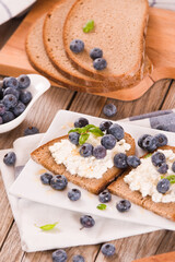 Rye bread with cottage cheese, blueberries and honey.