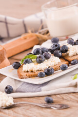 Rye bread with cottage cheese, blueberries and honey.