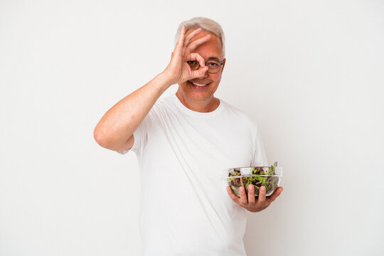 Senior American Man Eating Salad Isolated On White Background Excited Keeping Ok Gesture On Eye.