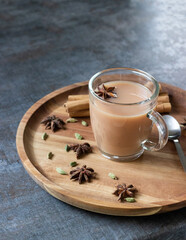 Masala tea served on a plate with spices