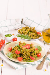 Fusilli pasta with cherry tomatoes and peas.