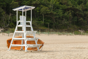 lifeguard tower with a boat on a seaside beach