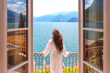 woman looking out window, woman on the balcony looking at the sea