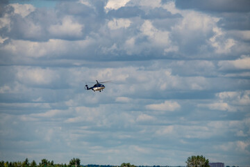 yellow sports plane in the air over the airfield 