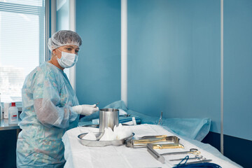 scrub nurse preparing medical instruments for operation
