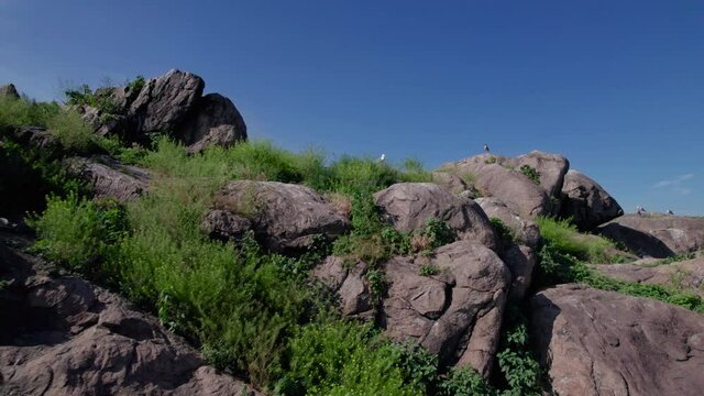 Nesting of big flock of seagulls, rocks and cliffs in river Dnieper. Drone view from the top on the dam DniproHES (Dnieper Hydroelectric Station), Dubovyi, Khortytsia Island, Zaporizhzhia, Ukraine. 4k