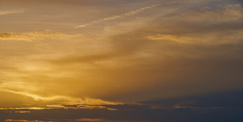 Naklejka na ściany i meble Colorful cloudy sky on the sunset as a natural background.