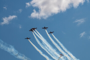 group of planes flying against the blue sky 