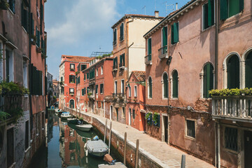 Fototapeta na wymiar Narrow canal by traditional Venetian house, Venice, Italy