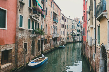 Fototapeta na wymiar Narrow canal by traditional Venetian house, Venice, Italy