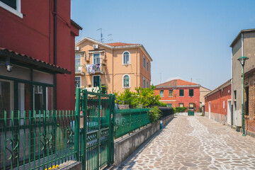 Fototapeta na wymiar Empty street between houses on island of Murano, Venice, Italy