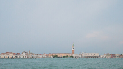 Fototapeta na wymiar Island of Venice under cloudy sky over water in Venice, Italy