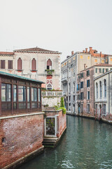 Fototapeta premium Narrow canal by traditional Venetian house, Venice, Italy