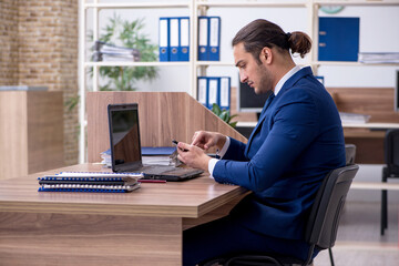 Young male employee working in the office