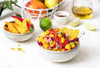 nachos with mango salad, onion and chili