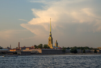 Saint Petersburg, RUSSIA-July, 15, 2021: view of the yellow tower with the spire of the Peter and Paul Fortress and the Neva River on a summer day and a space for copying