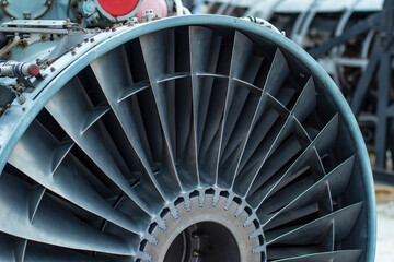 Close-up fragment of a shiny aircraft turbo jet engine blades with copy space: angle view