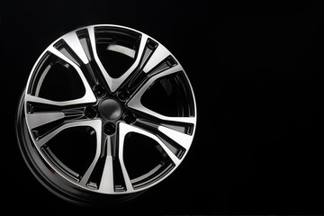 black with a polished front part suv car alloy wheel, copy space on a dark background