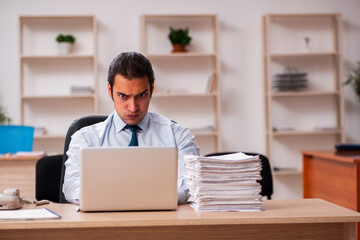 Young male employee unhappy with excessive work