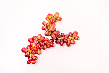Super refreshing bunches of red grapes on white surface