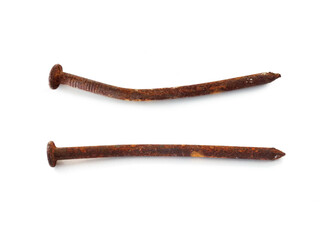 Aerial view of two rusty nails in horizontal position isolated. Close up of old wry rusty nail shot from above on white. Hardware store object.