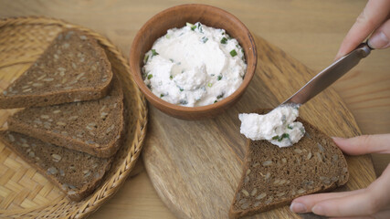 Fototapeta na wymiar Making healthy sandwiches with cottage cheese.Cream cheese spread on rye bread.