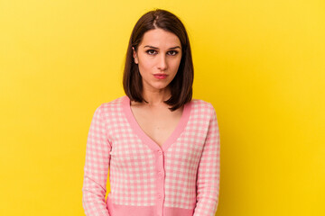 Fototapeta premium Young caucasian woman isolated on yellow background sad, serious face, feeling miserable and displeased.