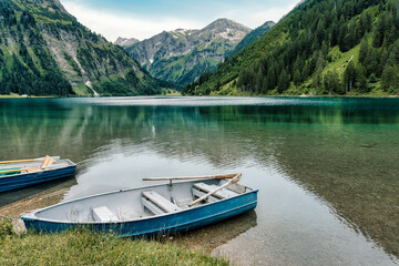 Scenic mountain lake in Austria. Vintage rowboat on emerald green, clear water alpine lake....