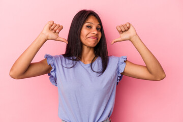 Young latin woman isolated on pink background feels proud and self confident, example to follow.