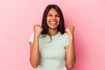 Fototapeta premium Young latin woman isolated on pink background cheering carefree and excited. Victory concept.