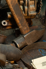 Old iron hummer with wooden handle and golden fill light in vintage rusty garage